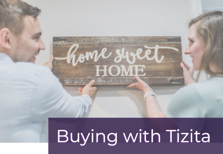 happy couple hanging Home Sweet Home sign with text Buying with Tizita